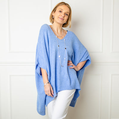 The dusky blue V Neck Pocket Poncho jumper with a v neckline and ribbed detailing along the bottom hemline